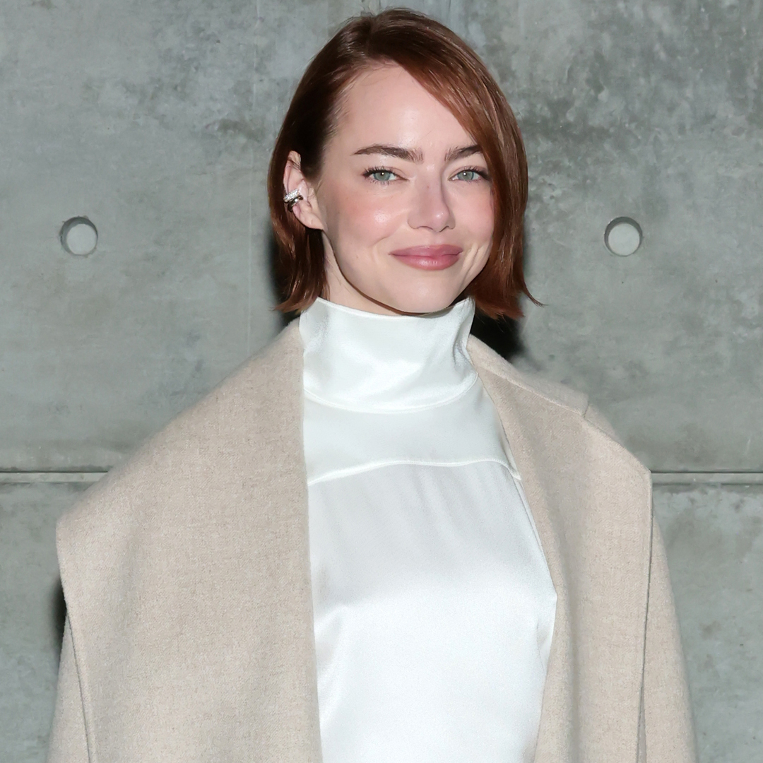 Emma Stone attended a Louis Vuitton bag in a white matching set, a beige coat, and a monogram Louis vuitton bag
