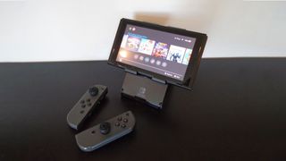 Nintendo Switch on stand with Joy-Cons detached.