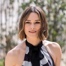 a white woman with short, brown hair posing for a photo outside