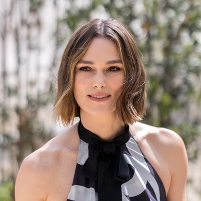 a white woman with short, brown hair posing for a photo outside