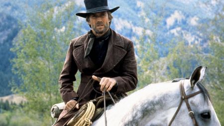 A still of Clint Eastwood riding a horse in the 1985 movie Pale Rider