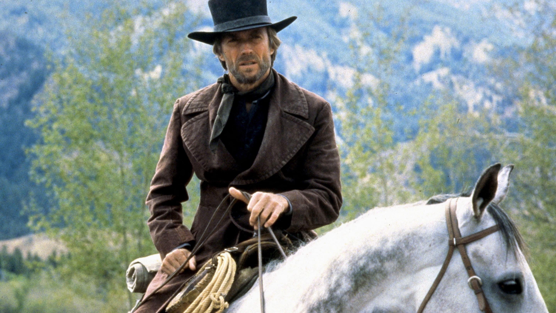 A still of Clint Eastwood riding a horse in the 1985 movie Pale Rider