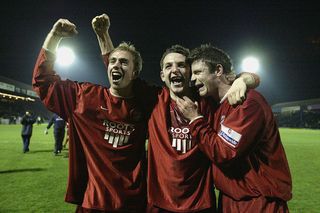 Scott Kerr of Scarborough (C) celebrates with team mates during the FA Cup Third Round match between Southend United and Scarborough at Roots Hall Stadium on January 3, 2004 in Southend, England. (Photo by Jamie McDonald/Getty Images)