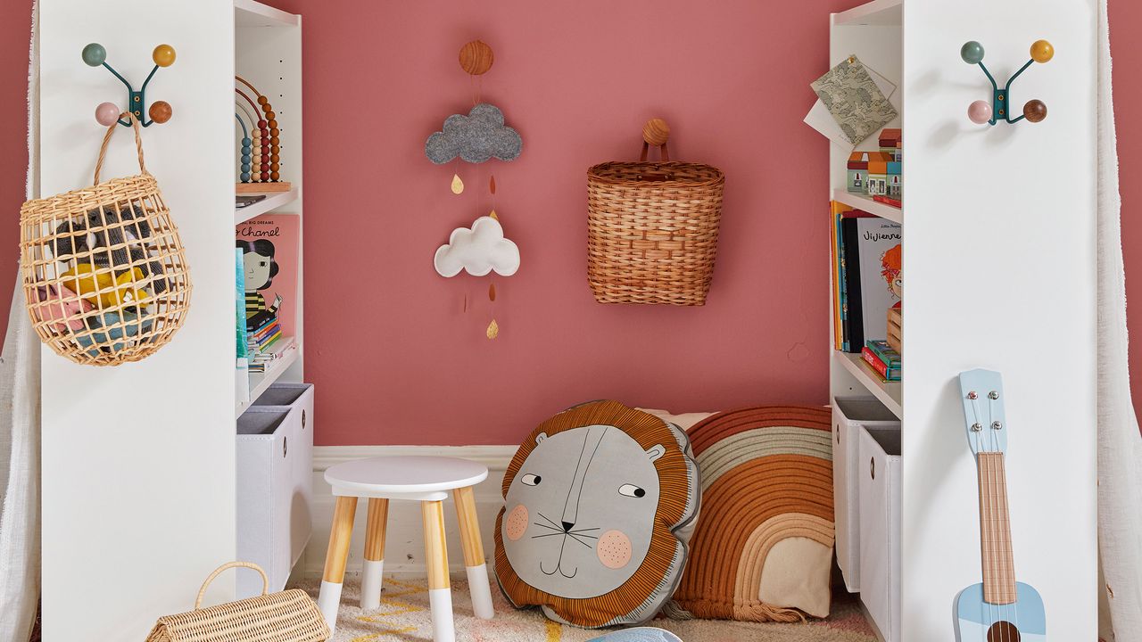 Reading area created with two white shelving units in a rich pink bedroom