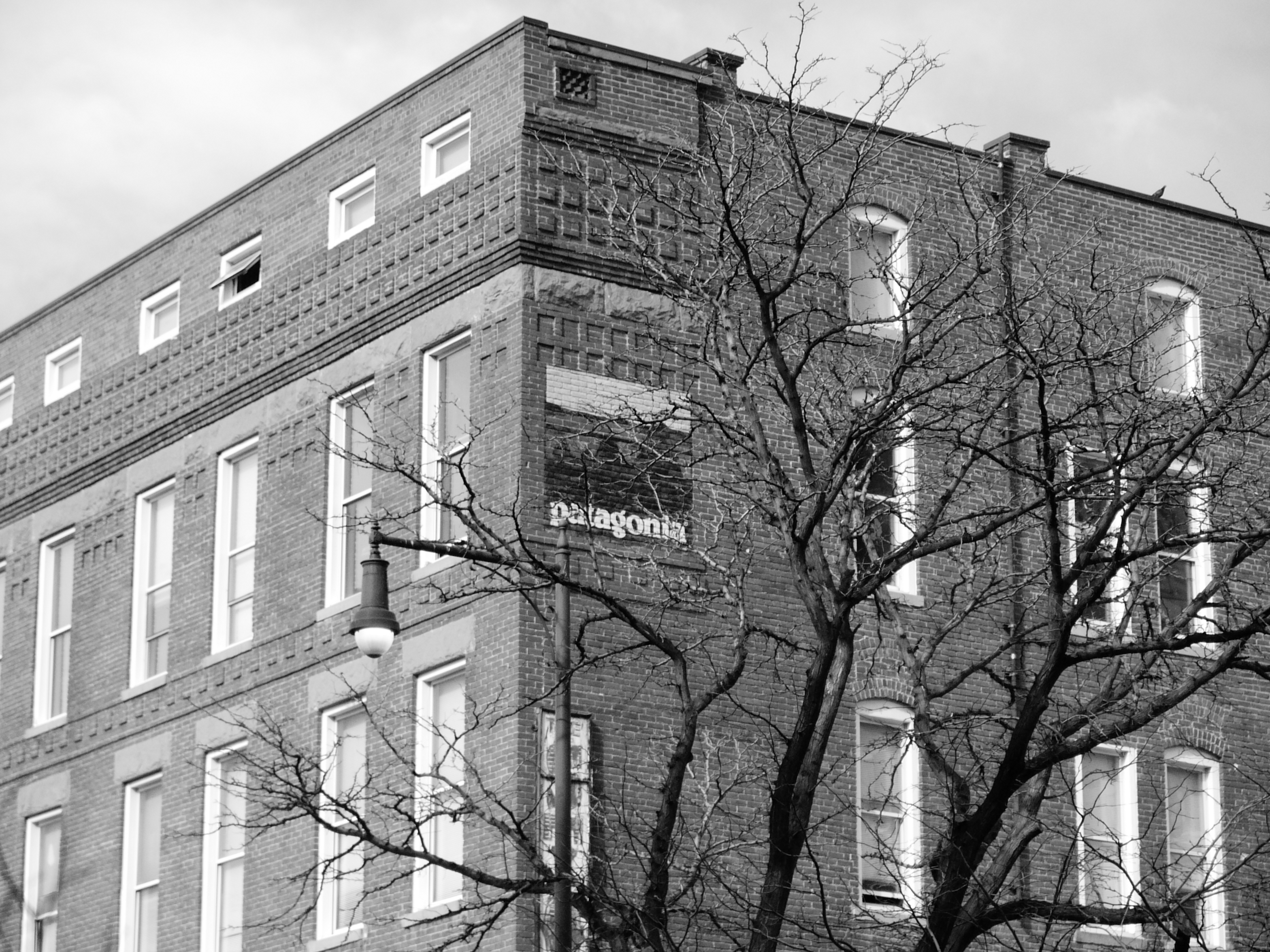 A street photo of a brick building, shot on the Lumix L1