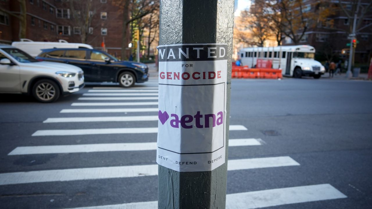 A poster accusing Aetna of genocide is seen in New York City after the assassination of UnitedHealthcare&#039;s CEO.