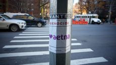 A poster accusing Aetna of genocide is seen in New York City after the assassination of UnitedHealthcare's CEO.