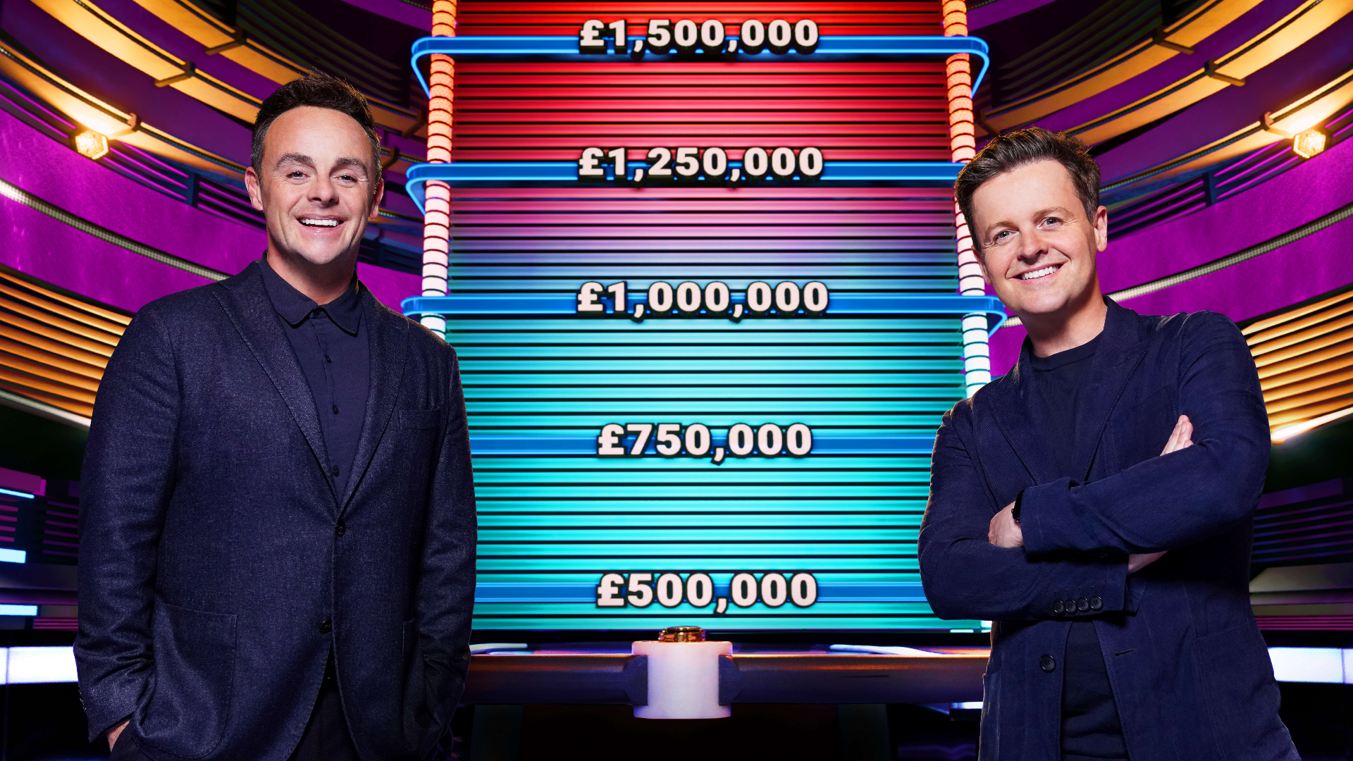 Ant and Dec poses in front of the Limitless cash board