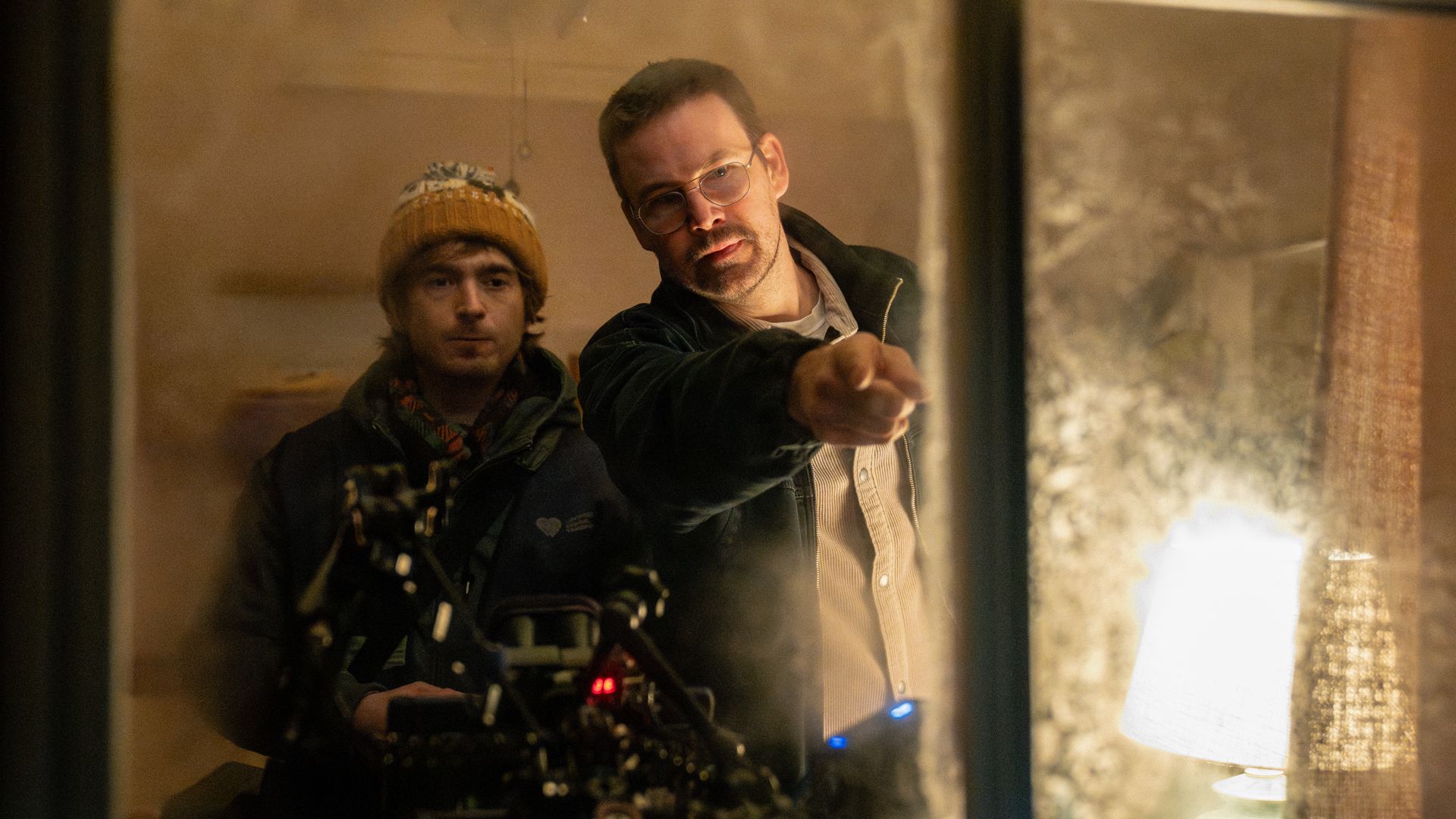Director Zach Cregger (right) and Austin Abrams on the set of Constantin Film and Columbia Pictures RESIDENT EVIL. Photo by: Dušan Martinček
