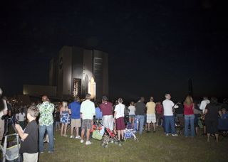 Thousands of spectators watch as space shuttle Atlantis makes its final debut outside the Vehicle Assembly Building at NASA's Kennedy Space Center in Florida, on May 31, 2011.