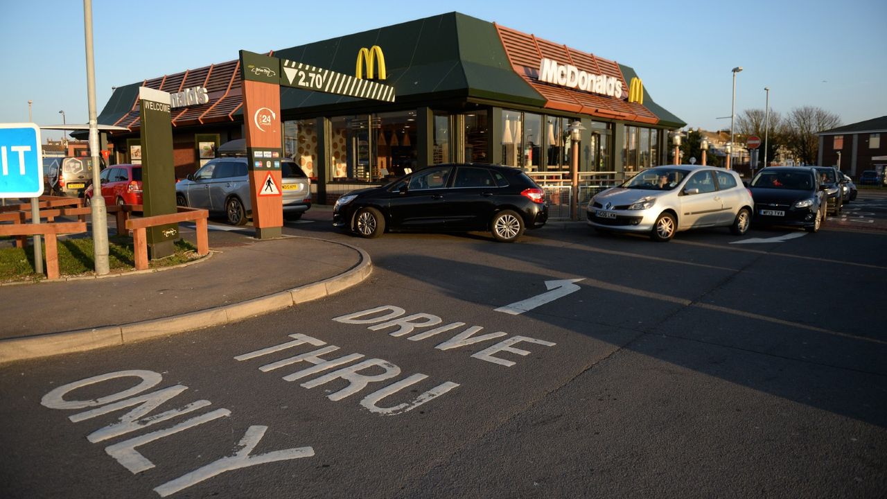 Long queues outside a McDonald&#039;s restaurant and drive thru prior to closure on March 23, 2020 in Weymouth, United Kingdom. Coronavirus (COVID-19) pandemic has spread to at least 182 countries, claiming over 10,000 lives and infecting hundreds of thousands more.