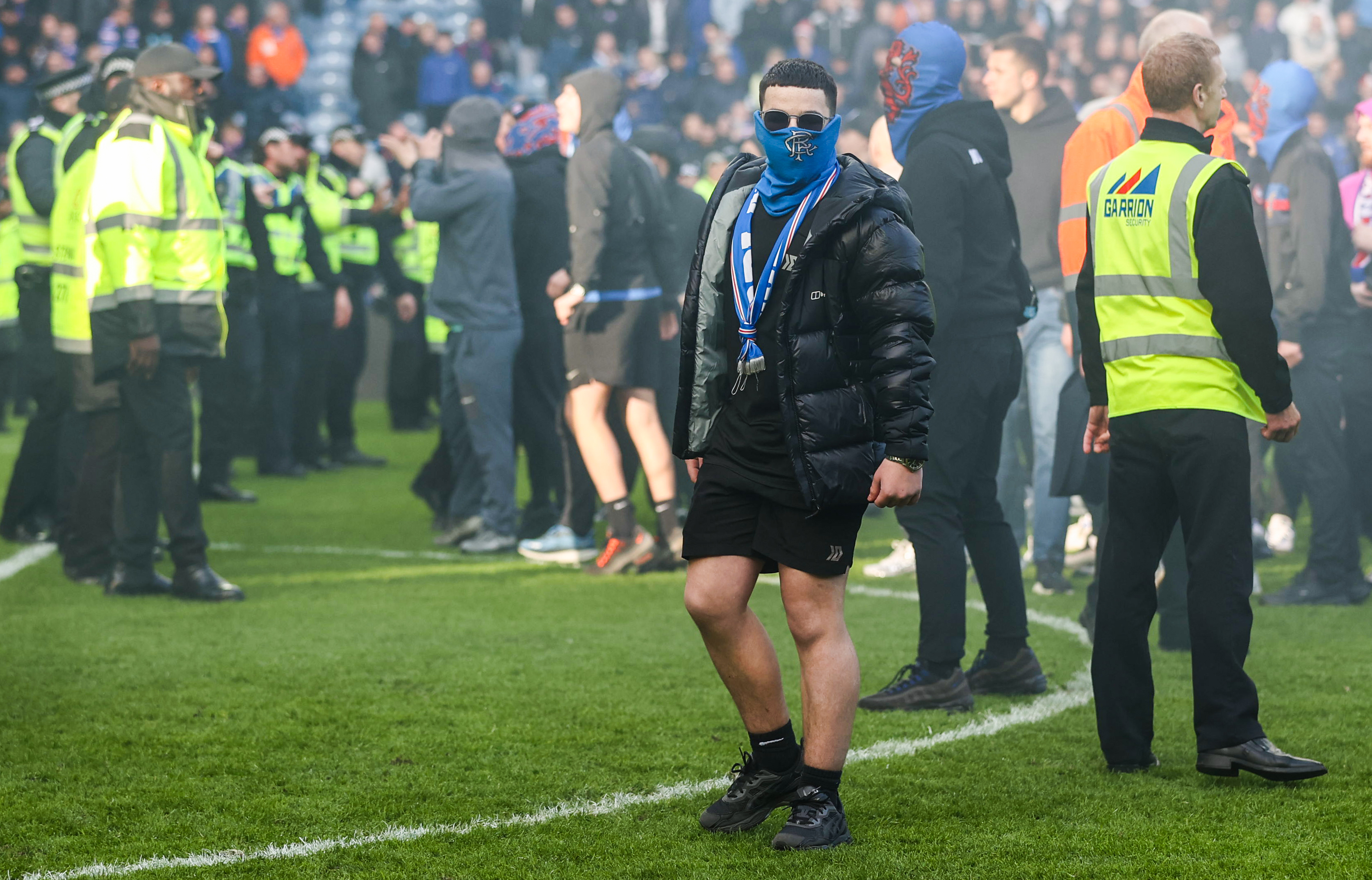 GLASGOW, SCOTLAND - MARCH 08: A Rangers fan on the pitch after fans storm the pitch at full time during a Scottish Gas Scottish Cup Quarter-Final match between Rangers and Celtic at Ibrox Stadium, on March 08, 2026, in Glasgow, Scotland. (Photo by Craig Williamson/SNS Group via Getty Images)