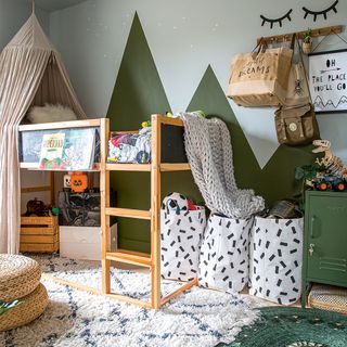 boys bedroom with green wall mural and bunk bed