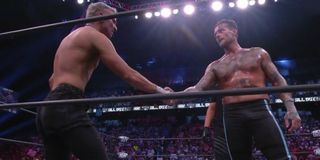 Darby Allin and CM Punk shaking hands following their match at AEW All Out 2021