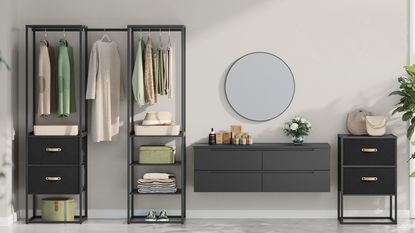 An open closet clothes rail next to a circular mirror and freestanding vanity