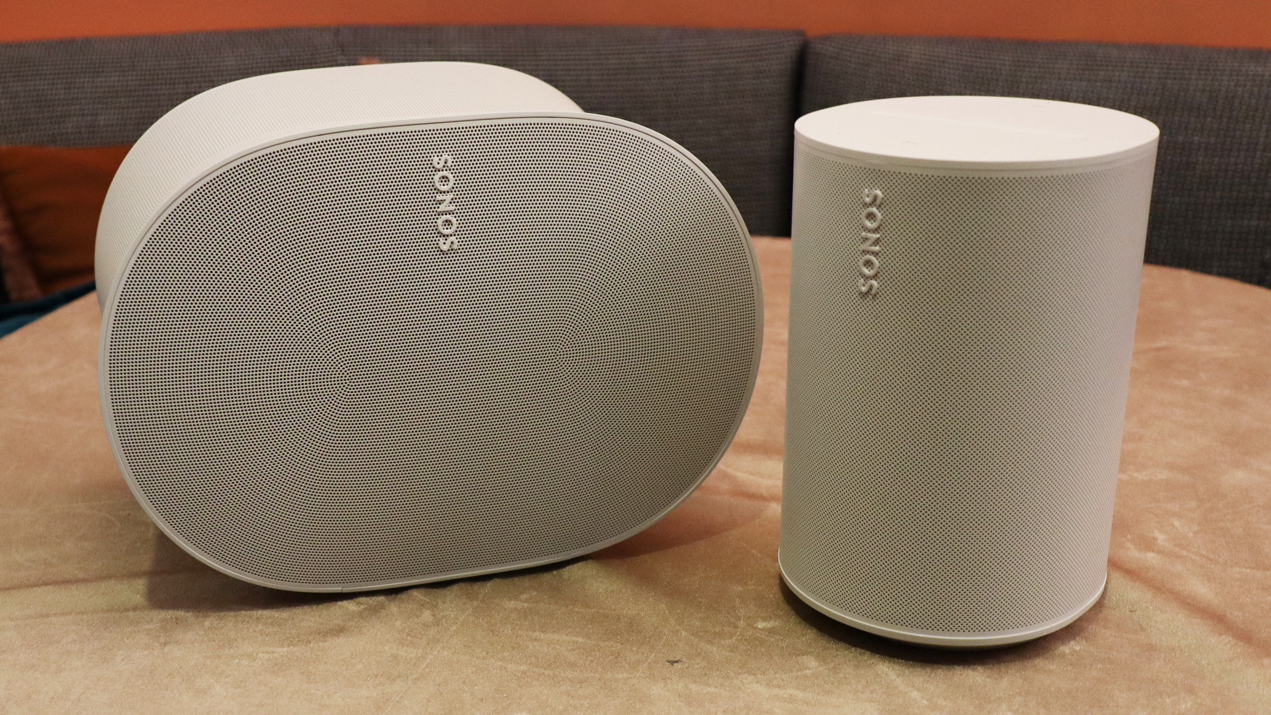 Sonos Era 100 and Era 300 speakers on a wood shelf