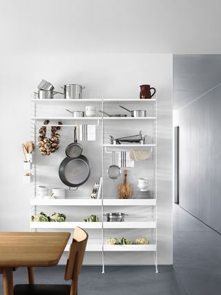 A white kitchen with open wire shelving