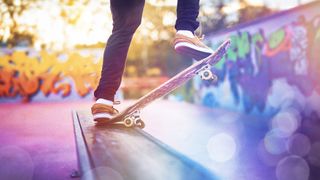 A skateboarder with bokeh in the foreground and a purple color palette graded in Adobe Premiere Elements 2025