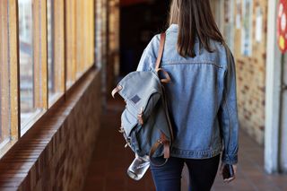 A student with her bagpack over one shoulder.