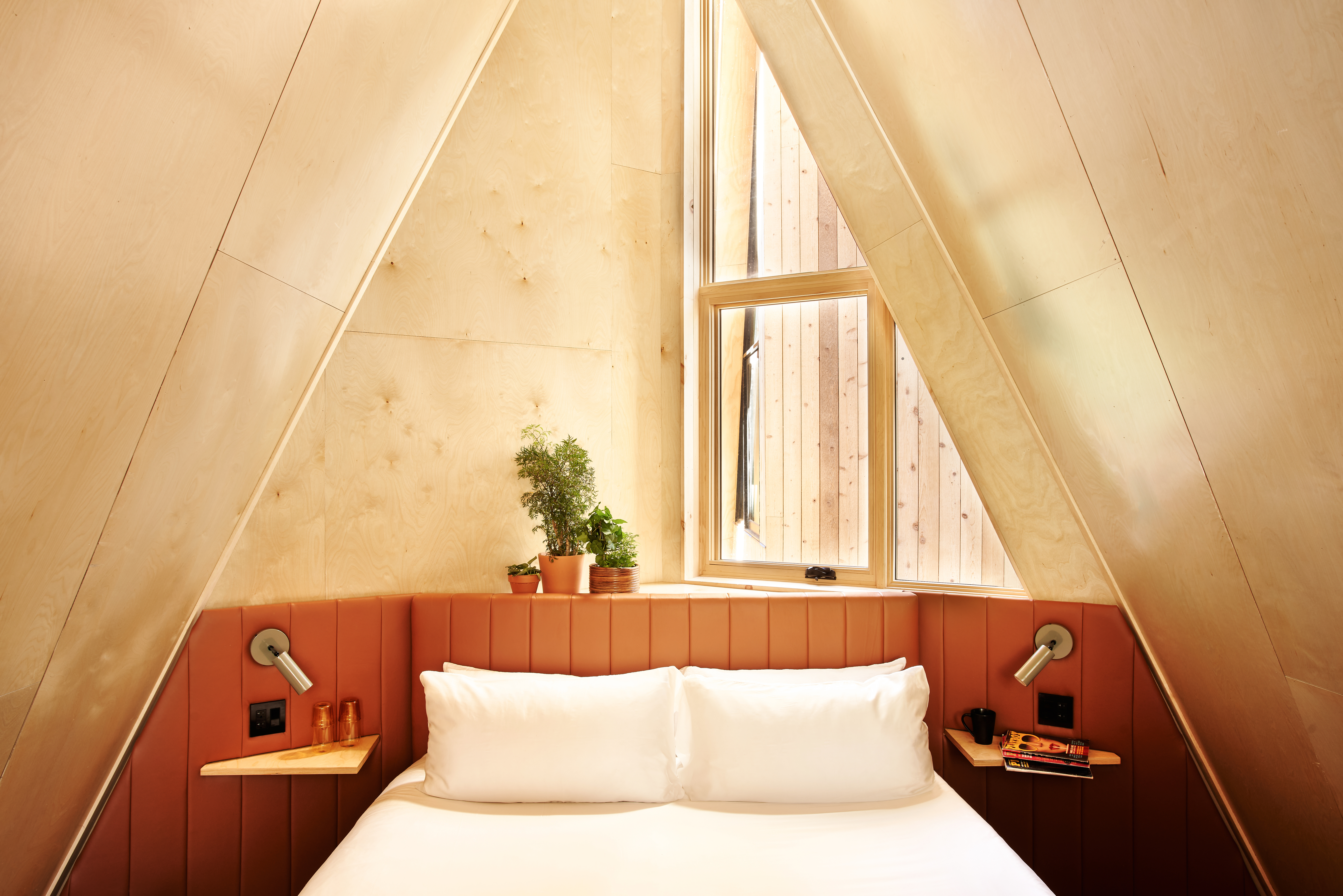 The bed inside an A-Frame Club cabin