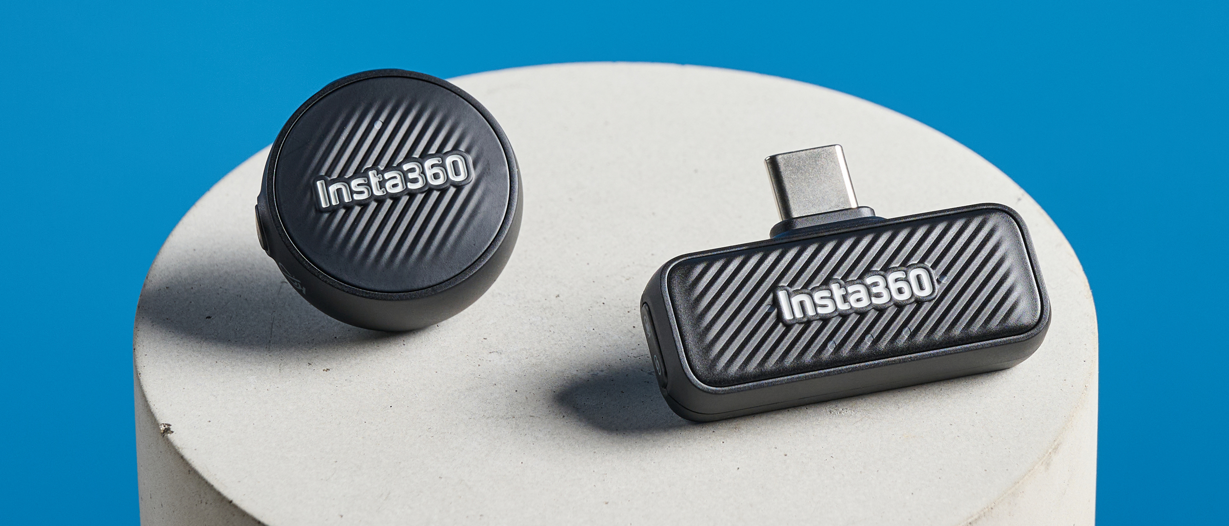 Insta360 Mic Air photographed on a blue background