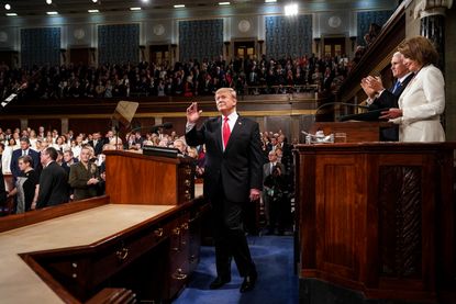 President Trump waves to the crowd in the House chamber
