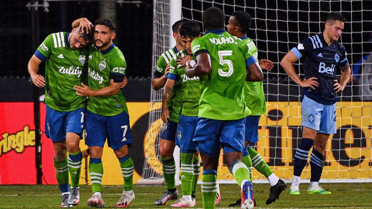 REUNION, FLORIDA - JULY 19: Jordan Morris #13 of Seattle Sounders FC celebrates with Cristian Roldan #7 after scoring a goal against Vancouver Whitecaps FC during a Group B match as part of MLS is Back Tournament at ESPN Wide World of Sports Complex on July 19, 2020 in Reunion, Florida.