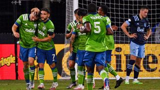 Jordan Morris of the Seattle Sounders FC celebrates with Cristian Roldan after scoring a goal against Vancouver Whitecaps FC at the MLS is Back Tournament on July 19, 2020 in Reunion, Florida.