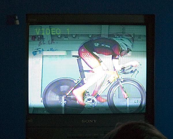 Wind tunnel staff monitors the athlete on monitors in the control room