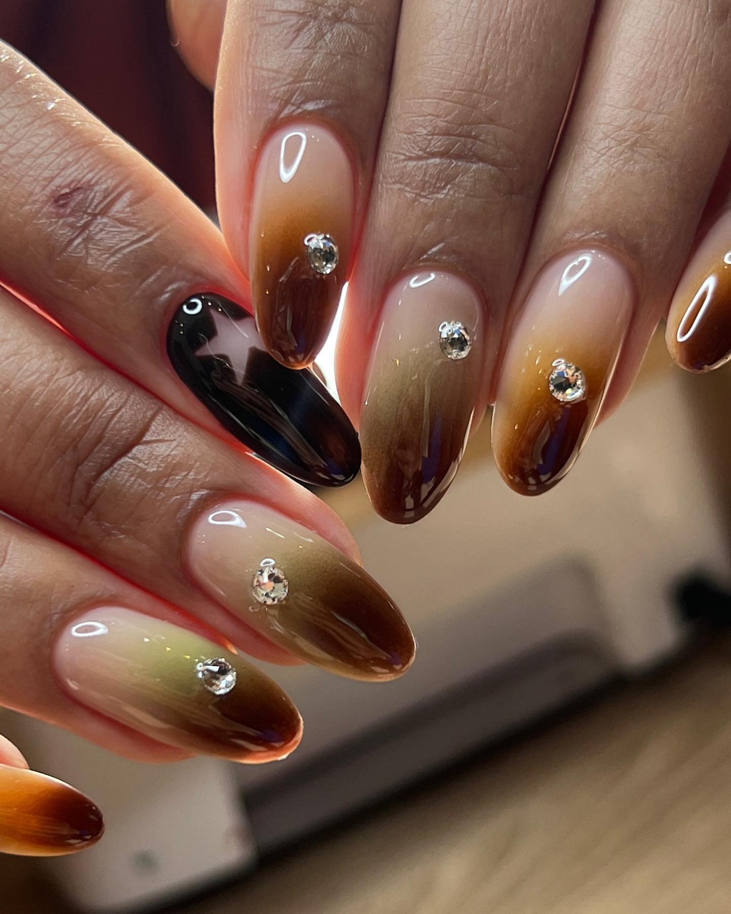 Ombre nails with cutouts and gems.