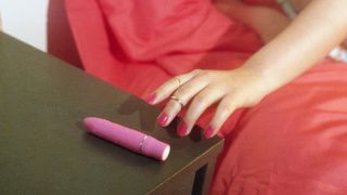 Woman reaching for pink vibrator