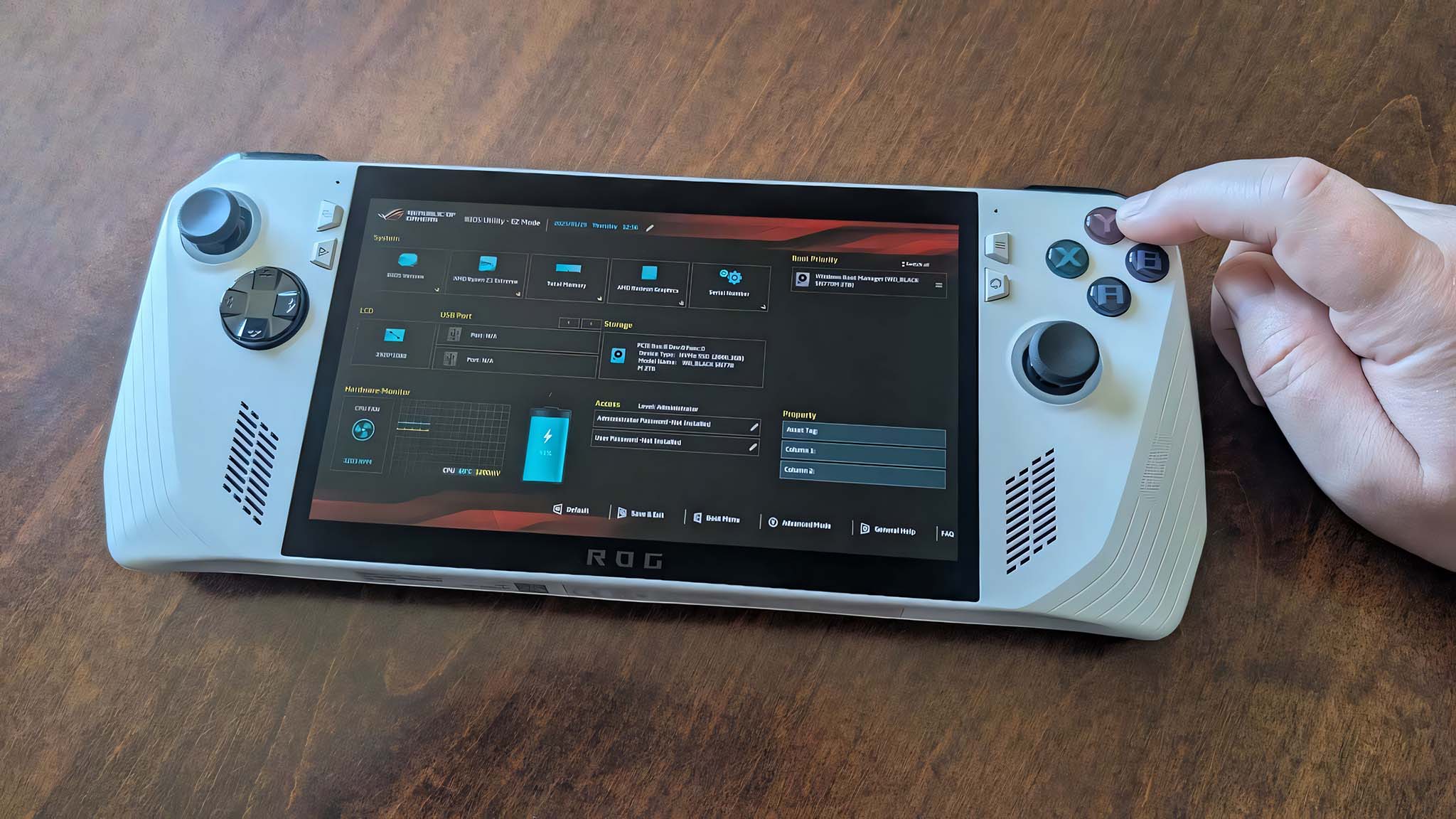 A finger pressing the Y button on ROG Ally while the BIOS is displayed on the screen.