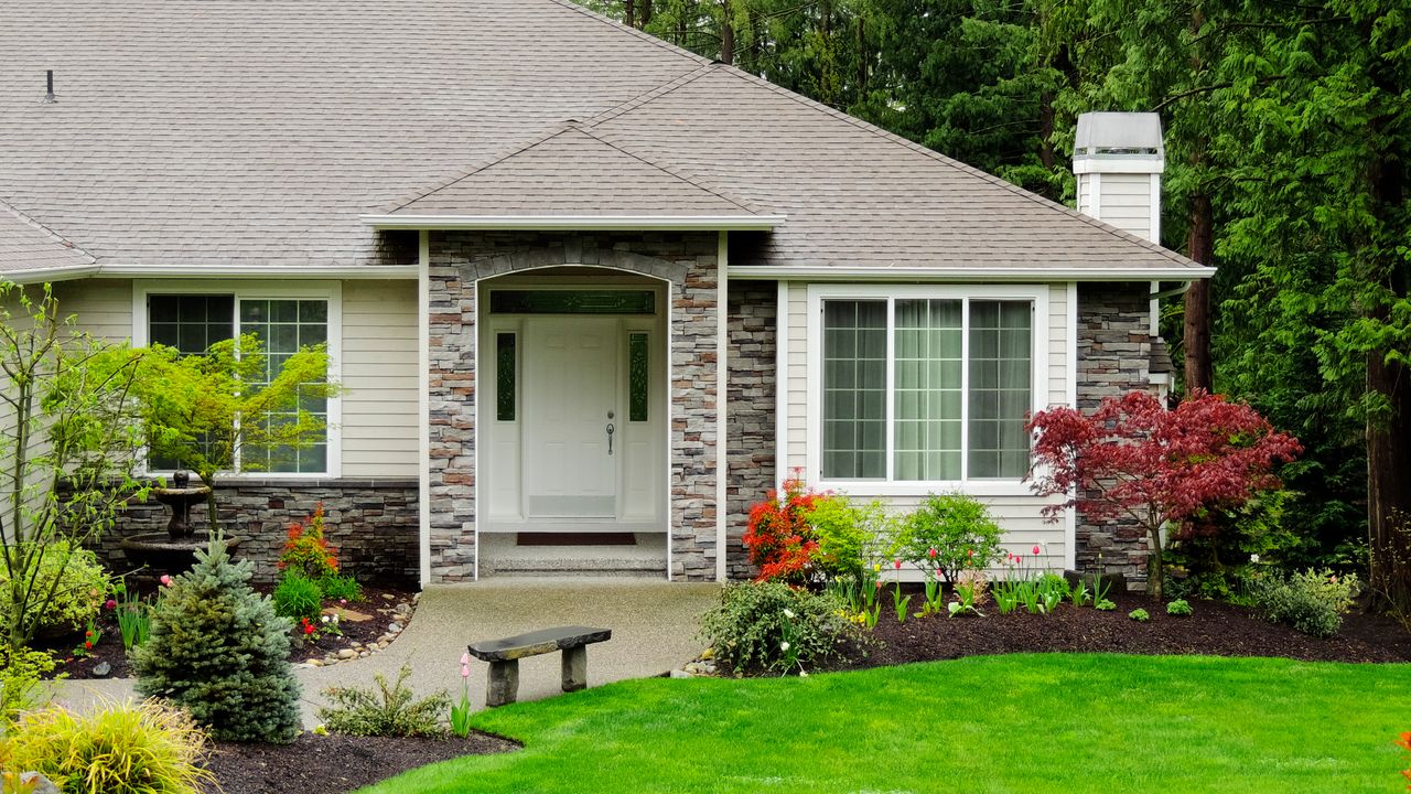 A small front yard with lawn and garden edging