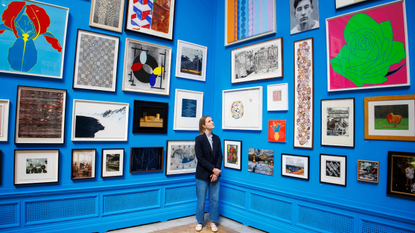 A visitor looks at a painting during the summer exhibition at the Royal Academy. 