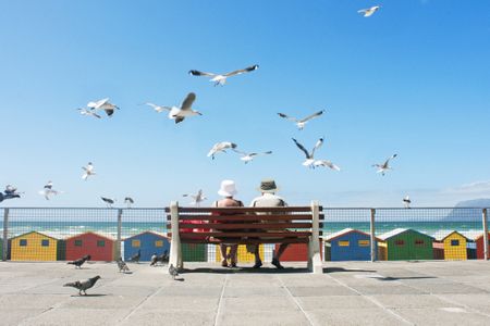 A senior couple enjoy lunch at Muizenberg Beach in Cape Town.