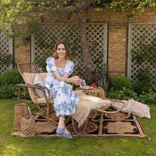 Louise Roe on rattan recliner in garden