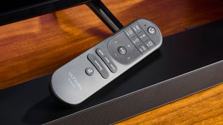 Ultimea Nova S50 soundbar with remote control balanced on top