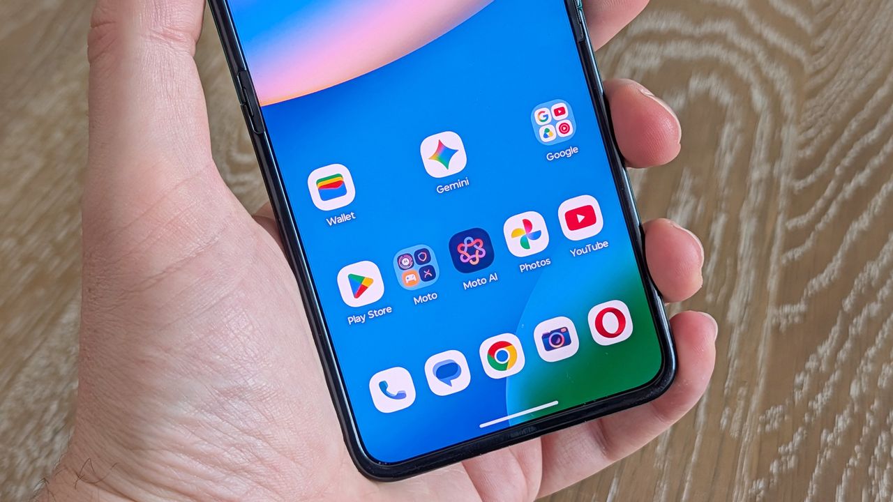 Motorola Razr 2026 in blue, being held in the hand
