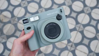 Fujifilm Instax Wide 400 camera held in a person's hand