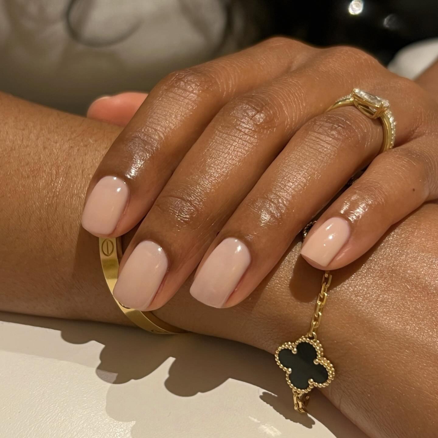A close-up picture of a nude milky manicure