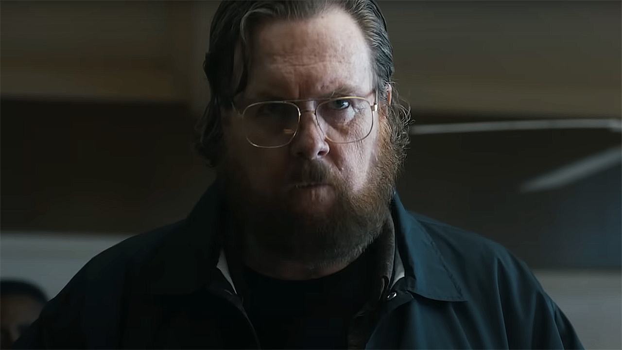 A close up of Jon Economos in Peacemaker season 2 episode 4
