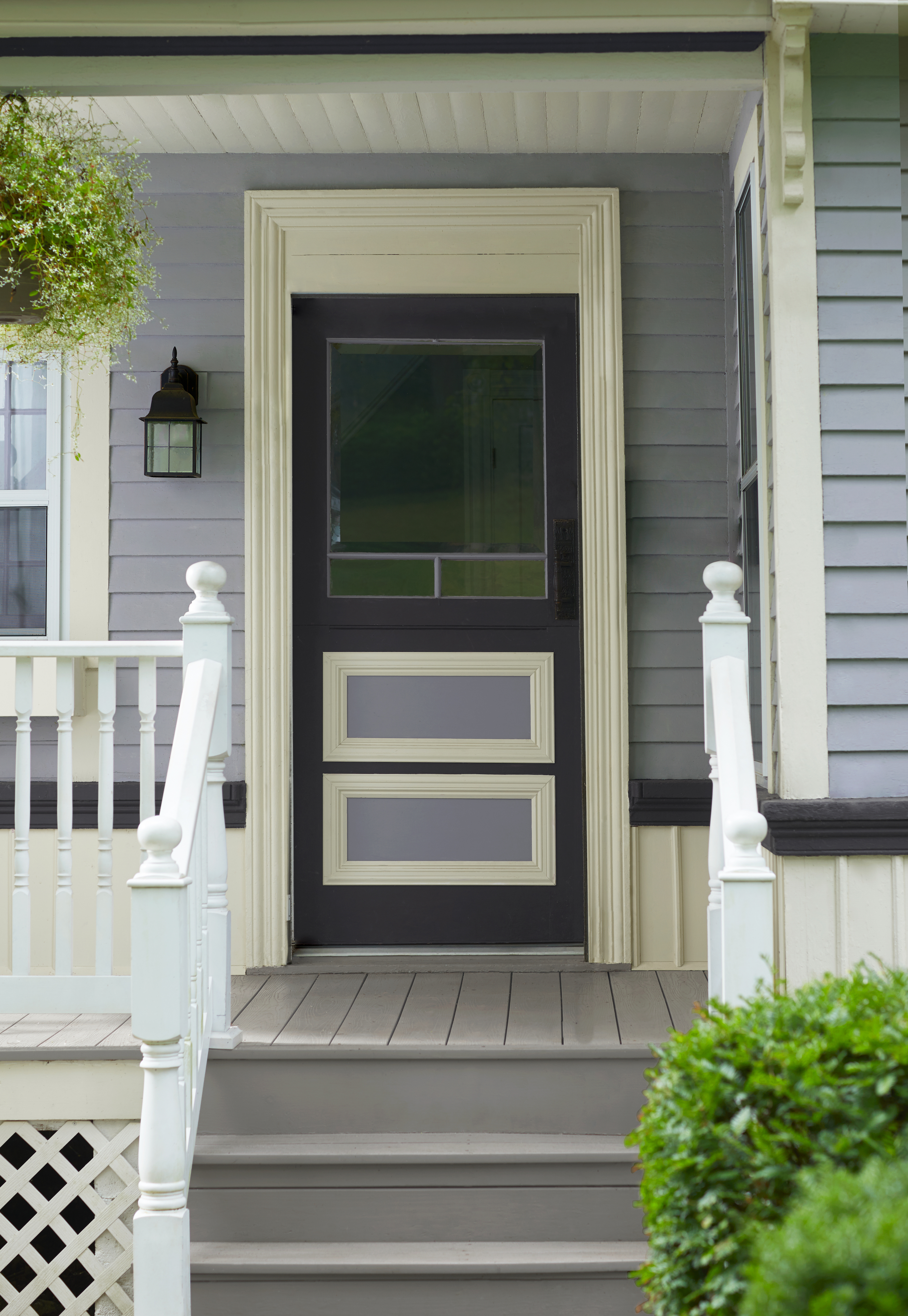 Exterior of house with gray siding with steps to porch and front door