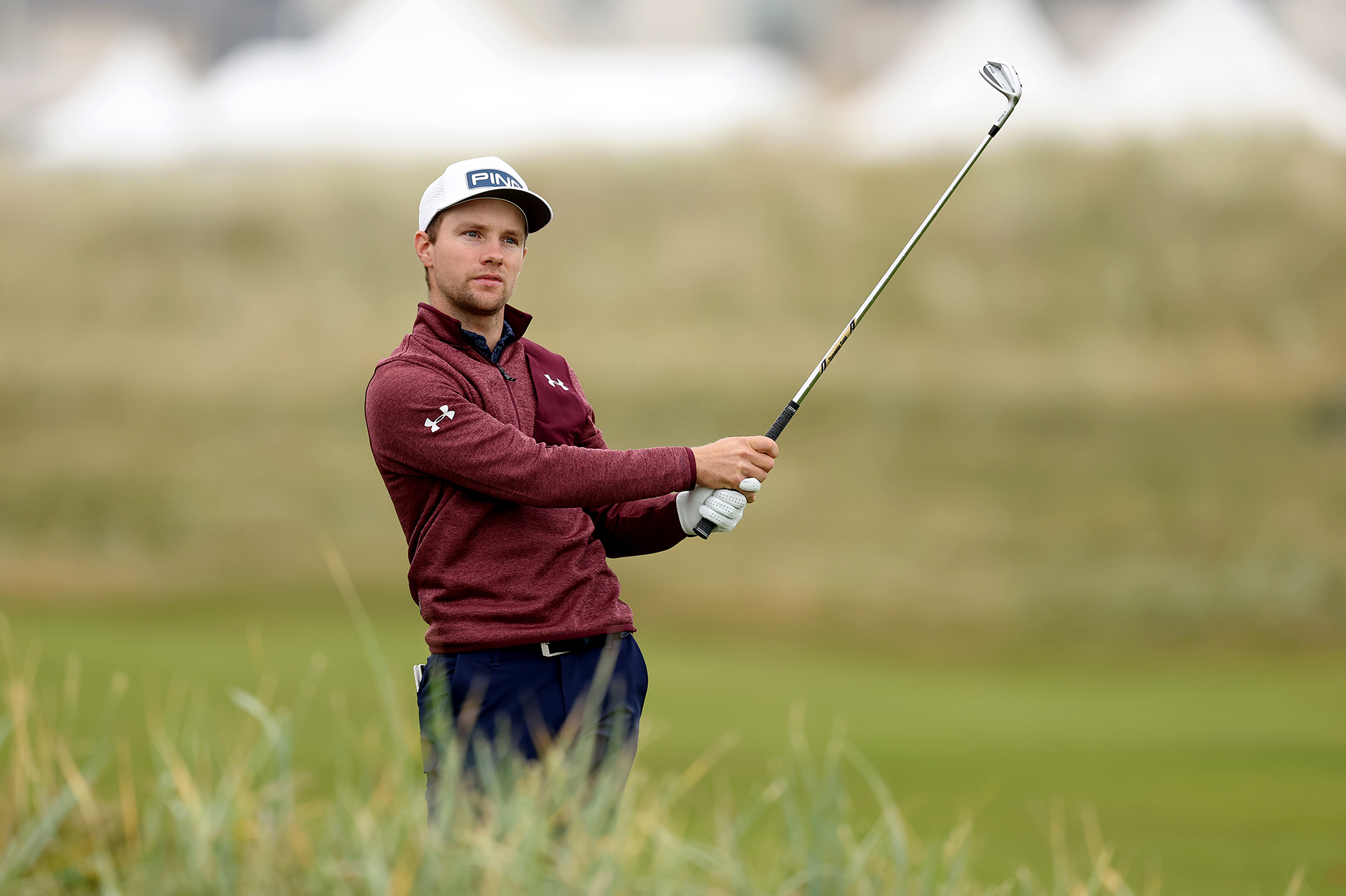 Rasmus Neergaard-Petersen in the finish position with a wedge and watching his ball flight