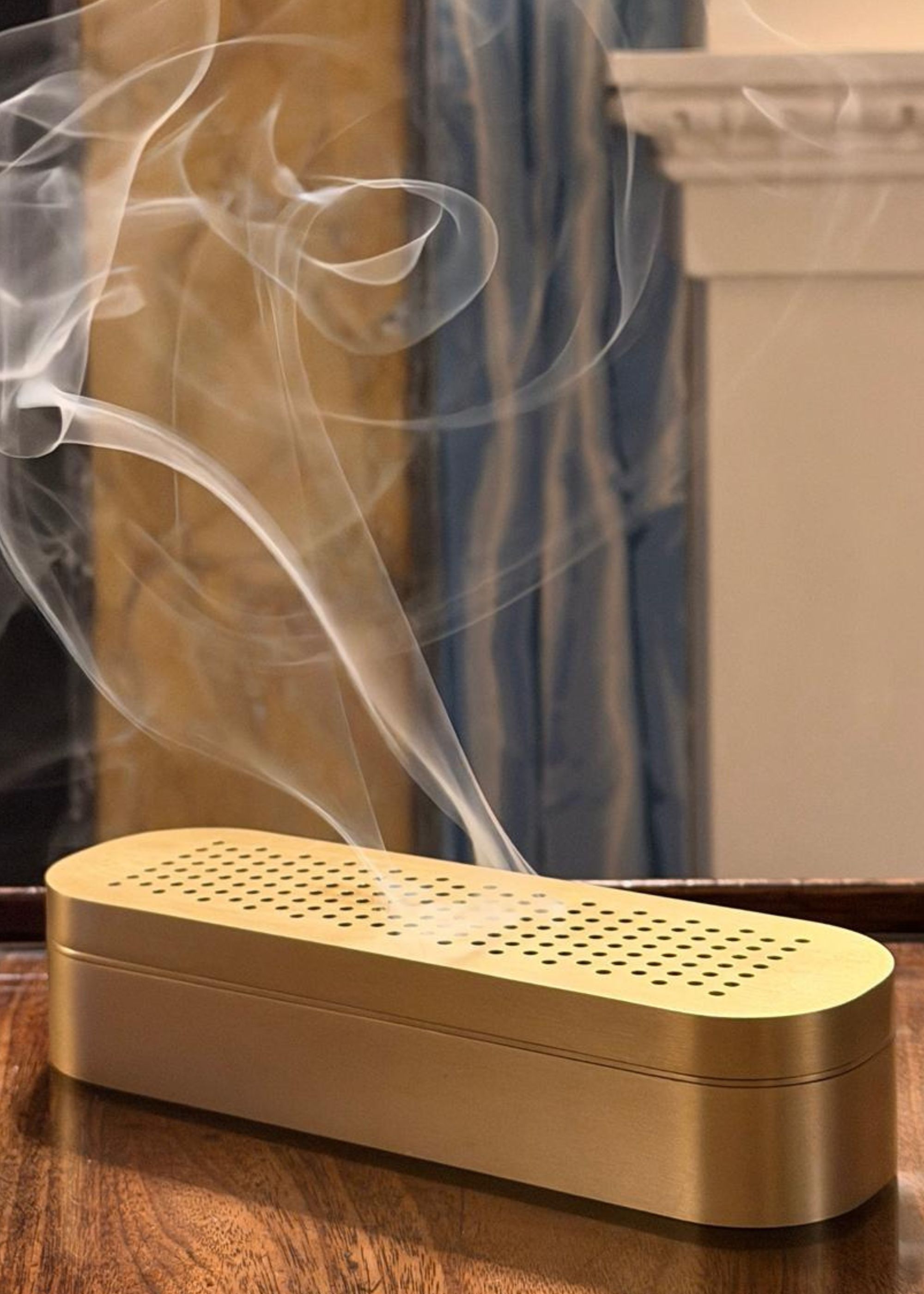A brassy gold incense burner from SUNDARA