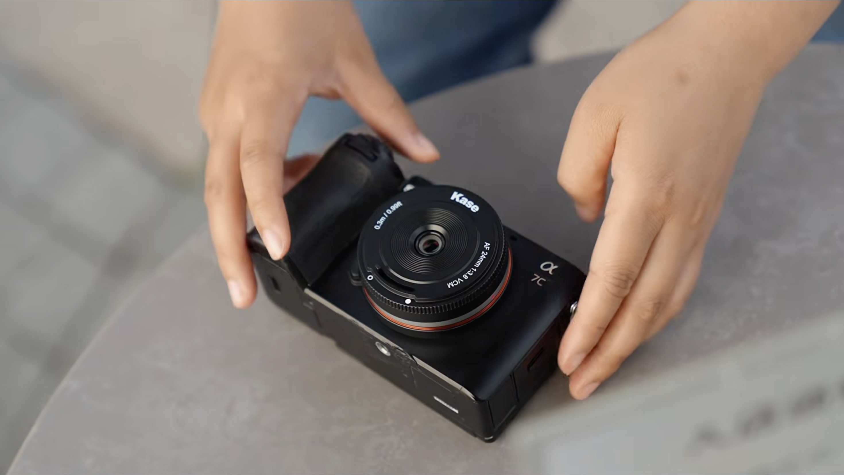 A photo of the Kase AF 24mm f/3.8 mounted on a Sony camera