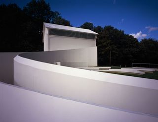 The decrepit house to create one double height room and rendered the whole building white