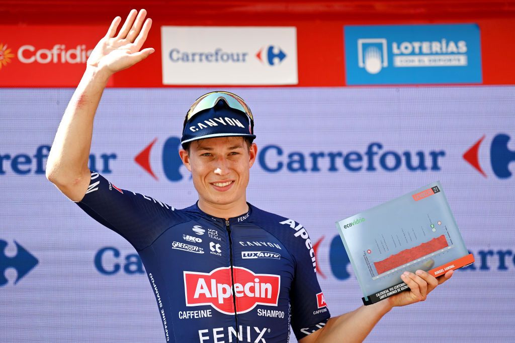 BURGOS SPAIN AUGUST 15 Jasper Philipsen of Belgium and Team AlpecinFenix celebrates winning the stage on the podium ceremony after the 76th Tour of Spain 2021 Stage 2 a 1667km stage from Caleruega Monasterio de Santo Domingo de Guzmn to Burgos Gamonal lavuelta LaVuelta21 CapitalMundialdelCiclismo on August 15 2021 in Burgos Spain Photo by Stuart FranklinGetty Images