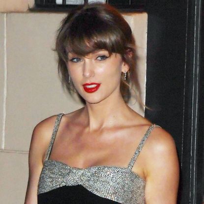 Taylor Swift was spotted after a family dinner in NYC wearing a bejeweled little black dress, matching peep-toe pumps, and her engagement ring