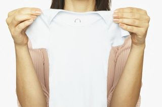 Woman holding a baby gro