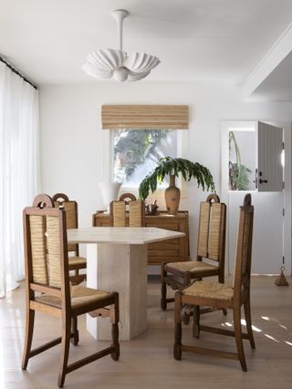 modern white dining room with rattan furniture